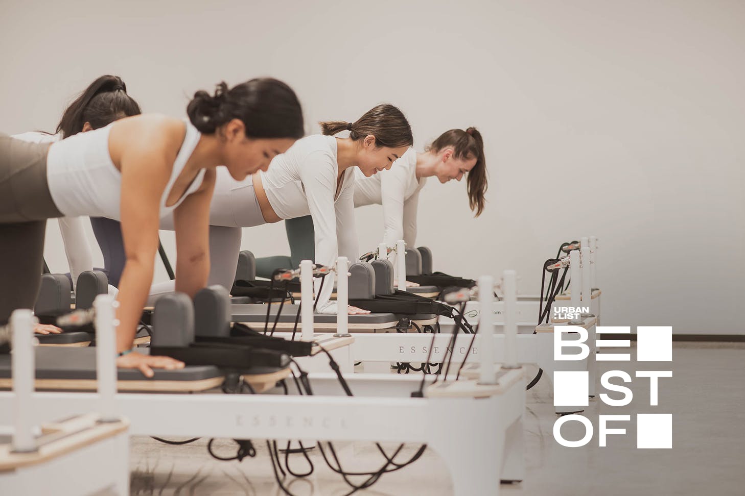 Three women do pilates on reformers at SO Fitness, one of Auckland's best pilates studios.